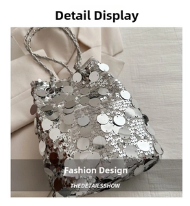 Detail of silver sequin bucket bag featuring large scales and woven chain strap