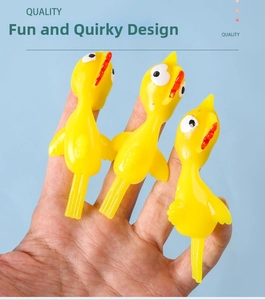 Detailed view of three yellow TPR rubber catapult chickens on a blue background