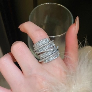 Detailed view of luxury silver wrapped ring with sparkling baguette and round zircons