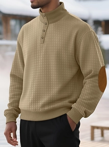 Detail of khaki waffle texture sweater with stand collar buttons and brown elbow patches