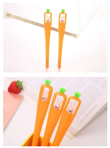 Close-up of creative carrot pens with cute rabbit dolls in a bright office setting