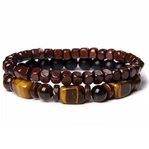Macro detail of natural tiger eye stones and wooden beads on a dual-layer bracelet