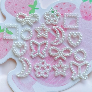 Collection of white ABS pearl charms in bow, star, moon and heart shapes for DIY jewelry making