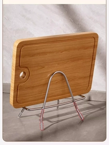 Detail of bamboo cutting board with water grooves and stainless steel storage rack