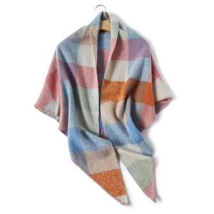 Detail of colorful block pattern cashmere-like scarf draped on wooden hanger