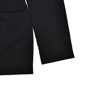 Detailed macro view of black woven blazer dress cuffs and pockets with refined stitching