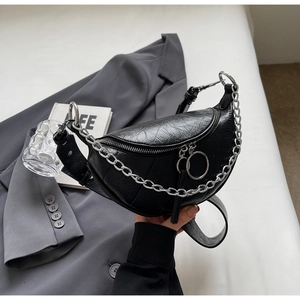 Detail of black PU leather saddle bag featuring silver metal chain and round zipper puller