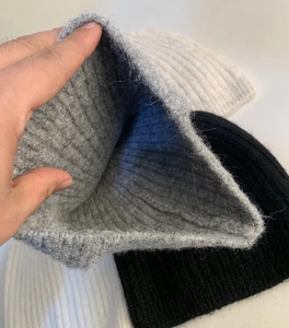 Close-up of the thick ribbed knit texture and interior lining of the wool blend beanie