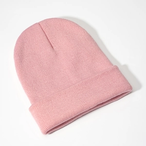 Detailed close-up showing the fine knit texture and folded cuff of this pink beanie