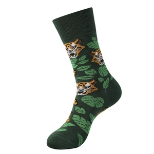 Detail of dark green crew socks with yellow tiger face and tropical leaf pattern
