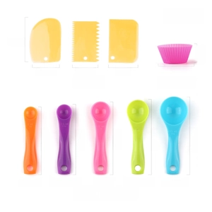Detailed view of kitchen baking set with plastic scrapers and colorful measuring spoons