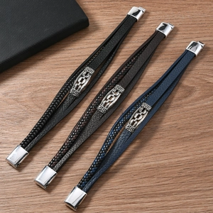 Detailed view of woven leather bracelets in black, brown, and blue with metal magnetic clasps