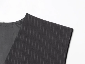 Detail view of dark grey pinstripe vest shoulder and collar with premium fabric texture