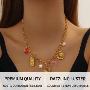 Close-up of bohemian gold necklace with sun and moon pendants on a female model