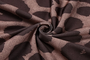 Detailed close-up of soft brown leopard print knit fabric showing rich fiber texture