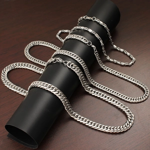 Hip hop stainless steel necklace set with cuban and link chains on dark wood