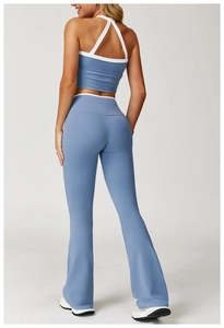 Back view of blue yoga set featuring contrast piping flared pants and a racerback crop top