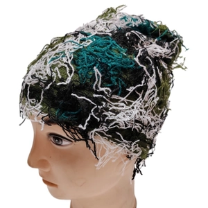 Knit beanie with green black and white fringe texture on a professional head model