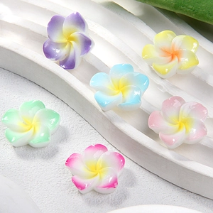 Colorful resin plumeria flower charms in various gradient shades for DIY hair accessories