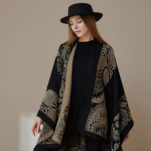 Close-up of black and khaki paisley patterned knit shawl wrap on model with hat