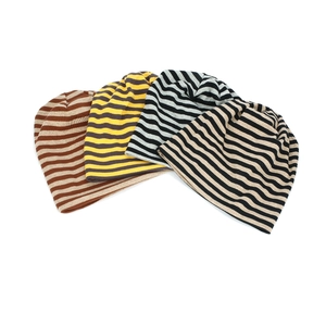 Detail view showing four color variations of striped cotton knit beanie hats for women