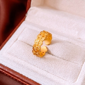 Detailed macro view of 24k gold plated vintage open ring with floral relief pattern