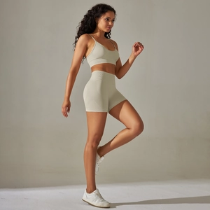 Detail of seamless knit yoga set in beige featuring high waist shorts and sports bra