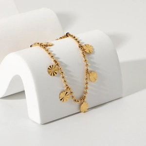 18K gold plated stainless steel anklet featuring beaded chain and sunburst petal charms