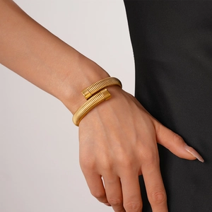 Detailed macro view of gold plated tubogas snake bracelet with metallic spiral texture
