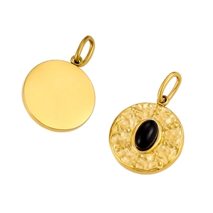 Detail view of round gold pendant with vintage hammered texture and black stone inlay
