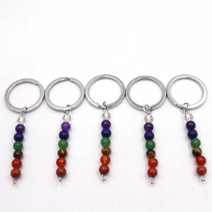Natural crystal seven chakra beaded keychains with metal ring on white background