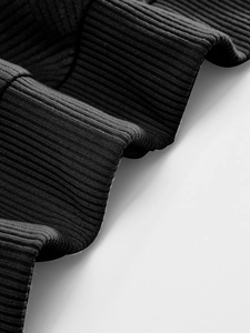 Macro shot of black heavy rib-knit fabric texture with vertical striped weaving detail