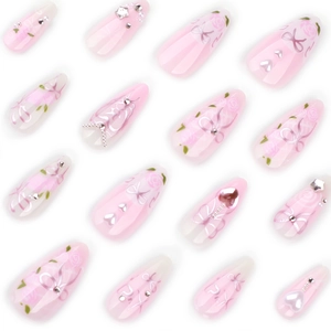 Pink almond press-on nails with 3D bows, roses, rhinestones, and pearls on white background