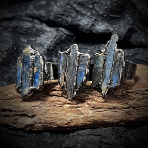Three-piece set of raw kyanite rings with vintage blackened silver finish on aged wood