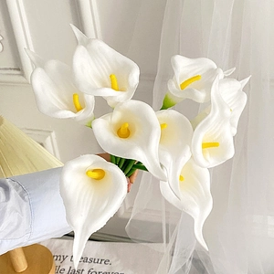 Elegant bundle of white PU Calla Lilies with yellow stamens and green stems for decor