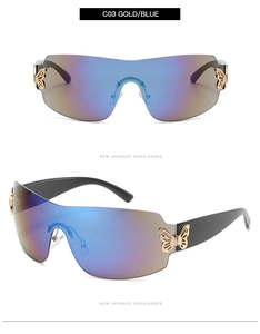 Close-up of gold butterfly hinge and blue gradient lens on rimless sunglasses