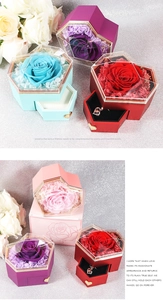 Macro detail of heart-shaped preserved rose jewelry box with drawer and golden handle