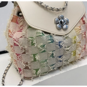 Detail of tweed and white leather crossbody bag with flower metal lock and chain strap