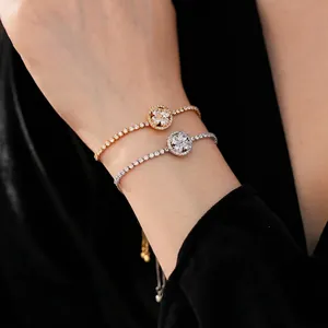 Rotating clover bracelet with cubic zirconia in gold and silver tennis chain design