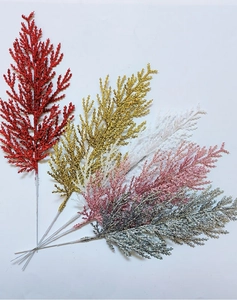 Detail showing five colors of glittery artificial pine branches for Christmas decoration