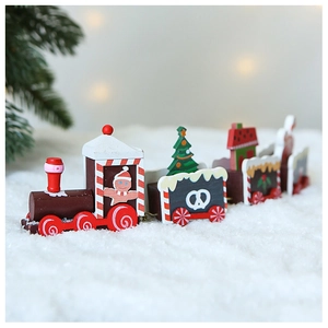 Close-up of a festive wooden Christmas train with gingerbread men on faux snow