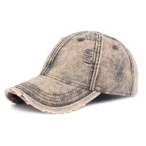 Detail of distressed ripped denim baseball cap in khaki with vintage washed finish