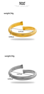 Macro shot showing dimensions of gold and silver spring coil bracelets with 34g weight