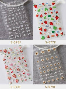 Detail view of 3D embossed nail art stickers with heart, strawberry, and flower designs