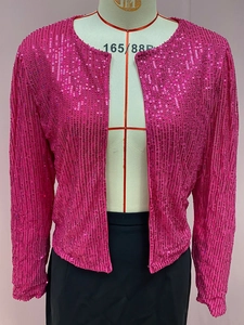 Close-up of vibrant magenta sequin jacket featuring a round collar and open front style