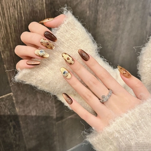 Handmade leopard cat-eye press-on nails with rhinestones for a bold winter look
