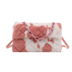 Pink and white plush cow print shoulder bag with diamond quilting and chain detail