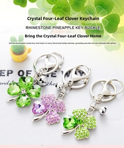 Detail of crystal four-leaf clover keychains with rhinestones in green and pink colors