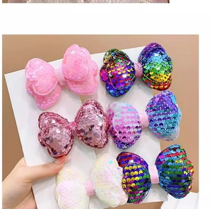 Set of six colorful sequin bow hair clips for girls in pink, purple, and rainbow shades