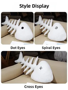Three plush fishbone pillows in white sherpa fabric with different embroidered eye designs